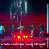 Santos Bravos perform on a neon-lit Billboard stage as five dancers move at 0:01