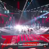 Santos Bravos perform on a neon-lit Billboard stage as five dancers move at 0:30