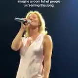 Ashe sings live on tour stage at 0:01