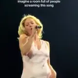 Ashe sings live on tour stage at 0:03