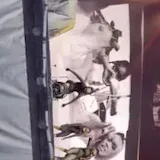 Dancers rehearse a tour number from the side of the stage under amber at 0:13