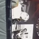 Dancers rehearse a tour number from the side of the stage under amber at 0:01