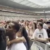 A camera sweeps an empty stadium and stage rig before a Victoria Monét at 0:04