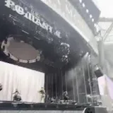 A camera sweeps an empty stadium and stage rig before a Victoria Monét at 0:01