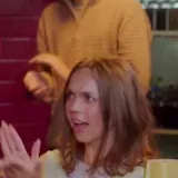 Sitcom scene: man tells crowd to keep joking at 0:05