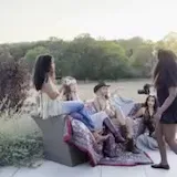 Women in cowboy outfits posing on patio at 0:07