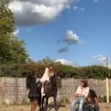 Erin Bloomer on horseback at video shoot at 0:28