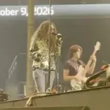 Live stage performance filmed from the crowd at 0:02